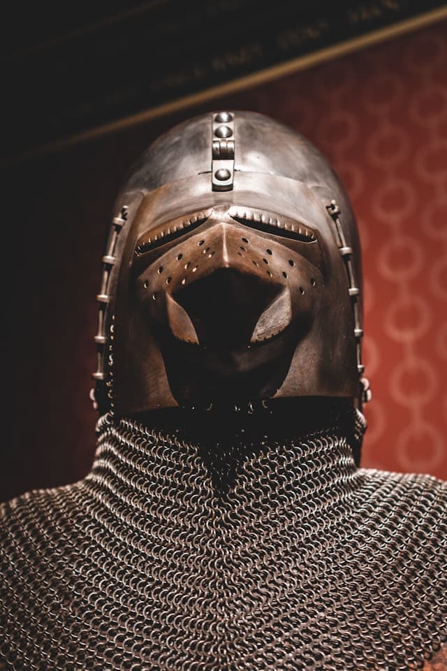 A photo of a knight clad in chainmail and a helmet.